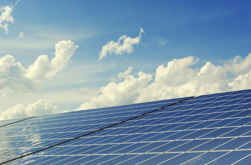 pexels photo 356036 356036 Sleek modern solar panels under a vibrant blue sky with clouds, symbolizing clean energy.