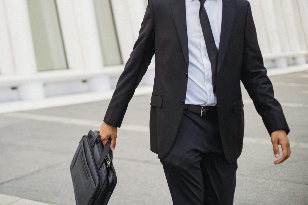 pexels photo 4964993 4964993 A businessman in a suit carrying a briefcase walks confidently outdoors, showcasing corporate professionalism.
